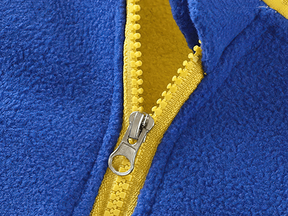 Close-up of zipper on Fleece Zip Jacket with Stand Collar and Pockets - SF3568 in blue with yellow trim for kids.