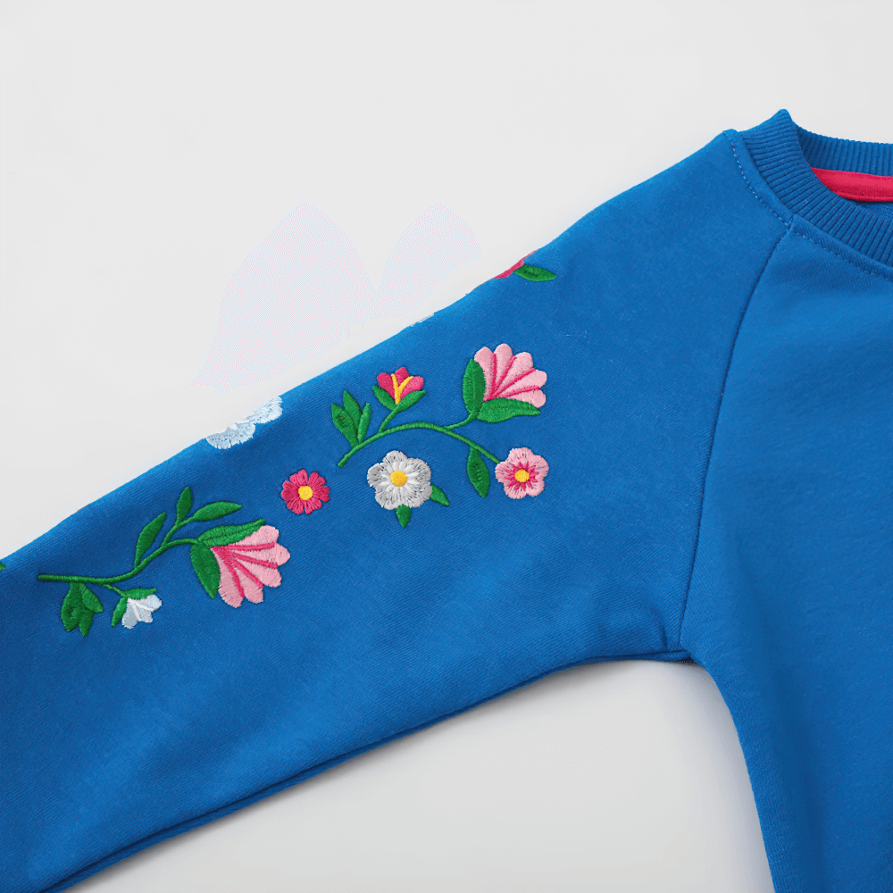 Floral Embroidered Sweatshirt With Raglan Sleeves - SF3634, showcasing vibrant floral detail on the sleeve of a blue girl's pullover.