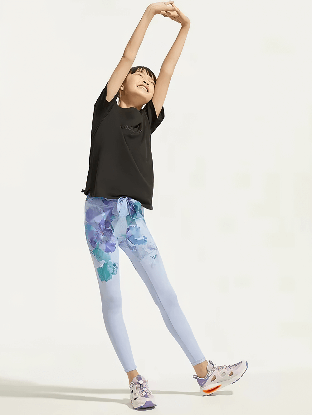 Girl stretching in Floral Print Girls Yoga Leggings with High Waist - SF3819, showcasing breathable spandex material and stylish floral design.