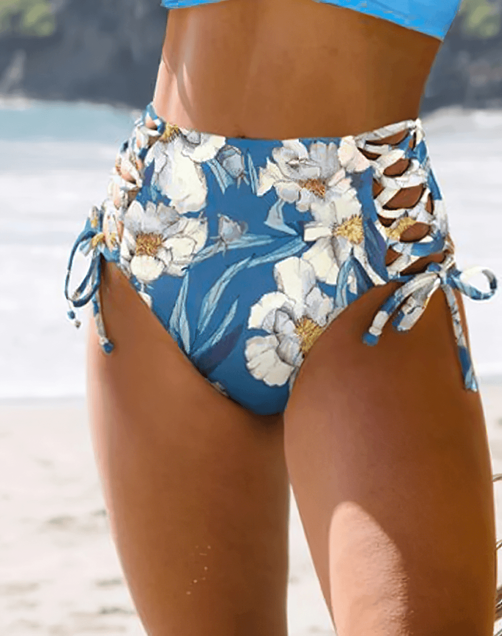 Showcasing the Floral Print V-Neck Tie Back High Waist Swimwear - SF4680 with elegant floral details in a beach setting.