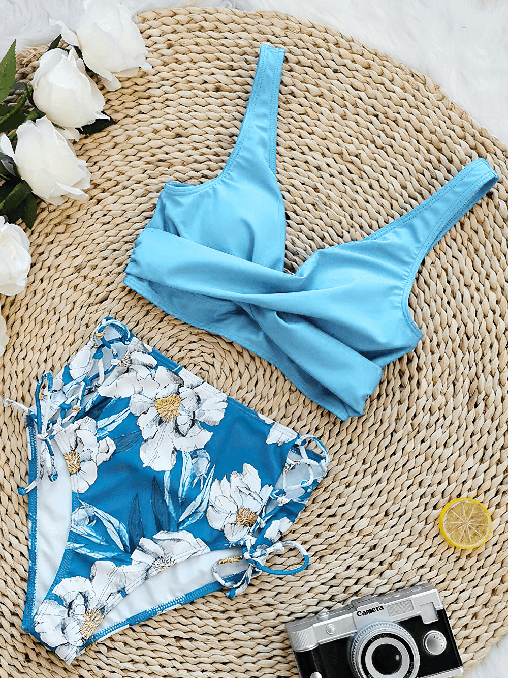 Floral Print V-Neck Tie Back High Waist Swimwear - SF4680 displayed on a stylish natural woven mat with a vintage camera.