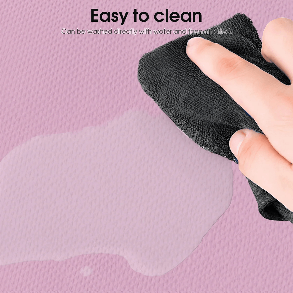 Cleaning the Foldable Non-Slip Yoga Mat SF3275 with a cloth to show its easy-to-clean feature on a pink surface.