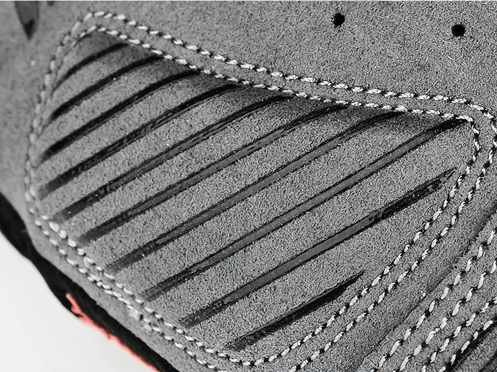 Close-up of the textured gray fabric with grooves, showcasing the design detail of cycling gloves for better grip and durability.