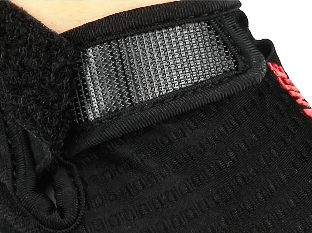 Close-up of black full-finger cycling glove with Velcro strap, showcasing breathable fabric and durable design for biking.