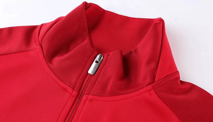 Close-up of red full zipper cycling jersey with a hooded collar, designed for male cyclists, featuring breathable polyester material.
