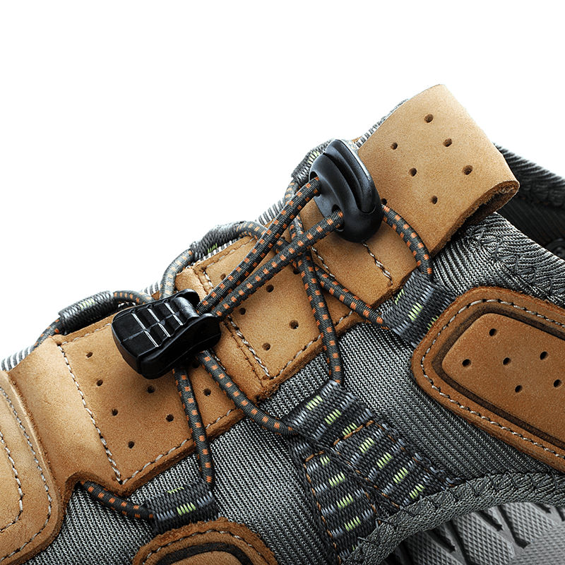Close-up of men's soft leather sandal with removable buckle and detailed stitching, showcasing craftsmanship and style.
