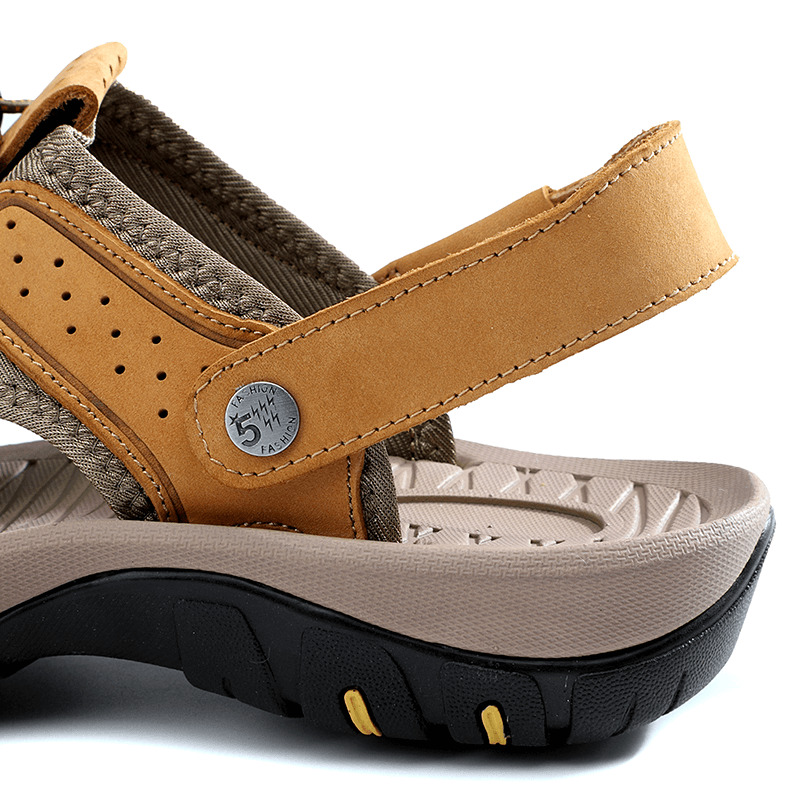 Close-up of genuine leather men's sandal with removable buckle and solid rubber sole for durability and comfort.