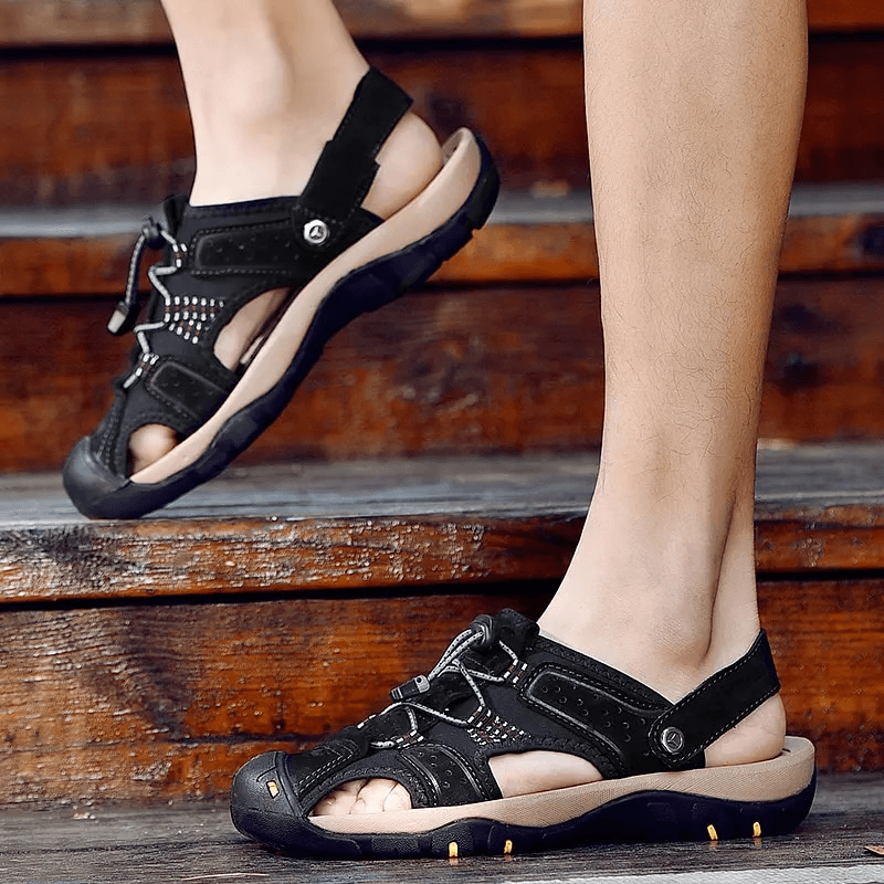 Man wearing Genuine Leather Men's Soft Sandals with Removable Buckle SF1378, showcasing comfort and style on wooden steps.