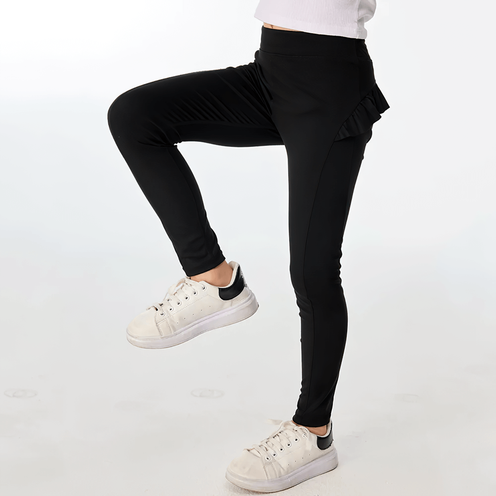 Girl demonstrating movement in Girls Athletic Leggings with Ruffled Waistband - SF3622, perfect for dance, yoga, and running.
