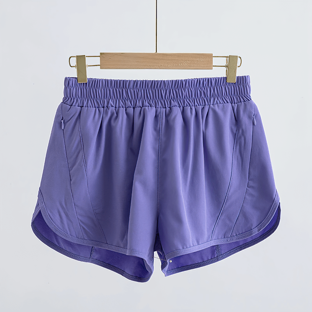 Girls Athletic Running Shorts with Drawstring Fit - SF3769 in purple color, lightweight with pockets, hanging on a wooden hanger.