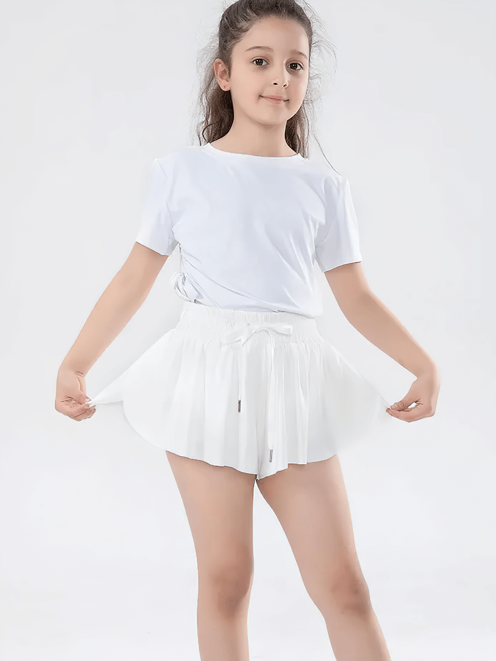 Girl wearing Girls' Bright Sports Shorts with Pleated Design - SF3829, showcasing vibrant color and pleated style for active days.