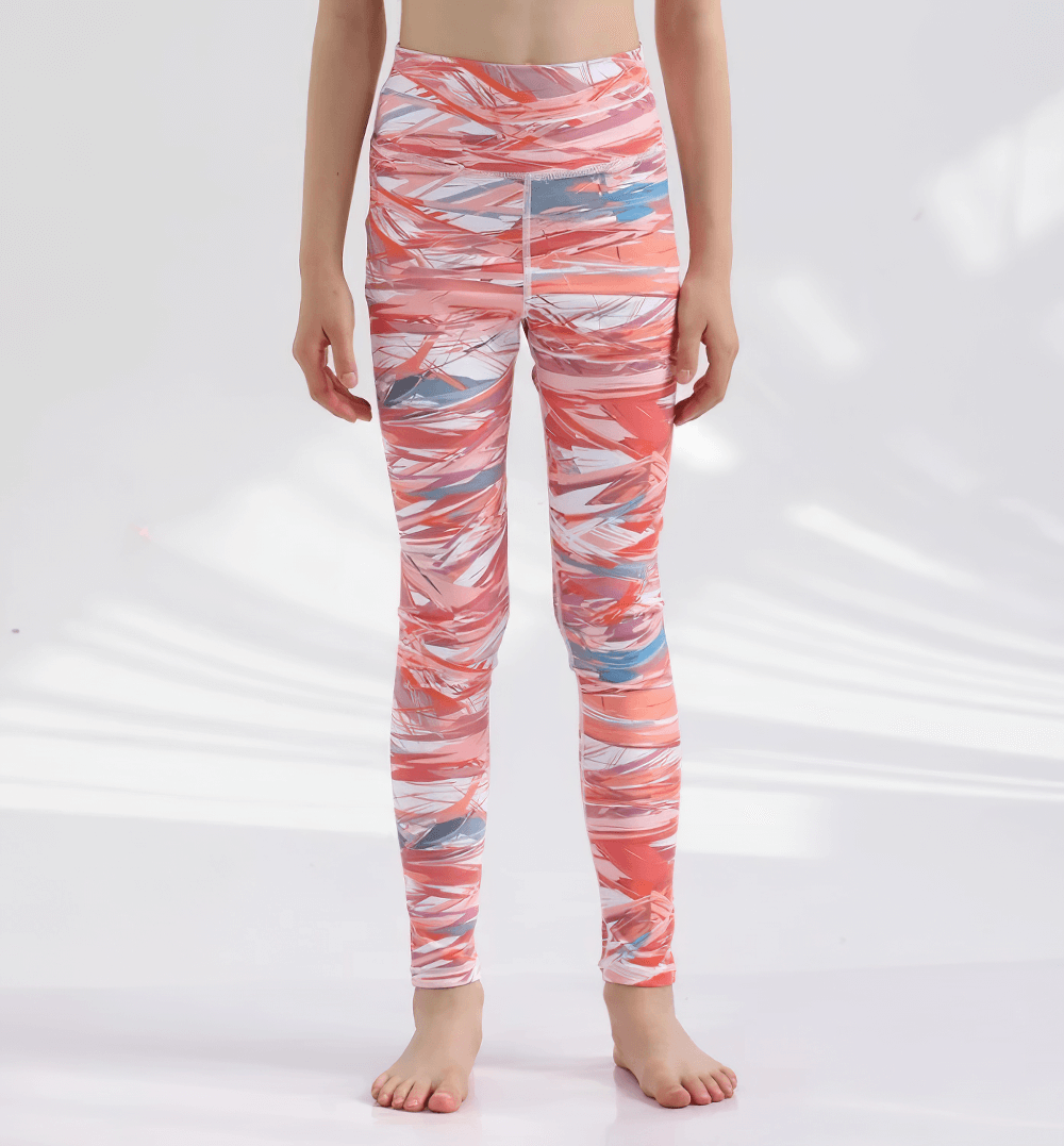 Cheerful girl modeling Girls Colorful Yoga Leggings for Active Wear - SF3623 with tie-dye design, standing on bright background.