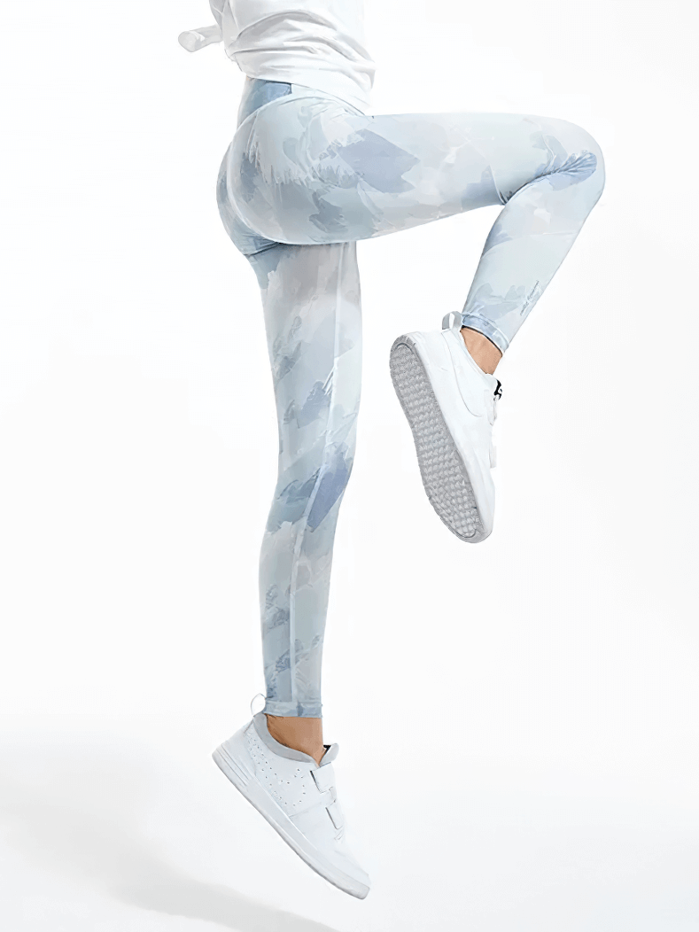 A model in Girls Colorful Yoga Leggings for Active Wear - SF3623, showcasing a dynamic pose while wearing stylish tie-dye leggings and sneakers.