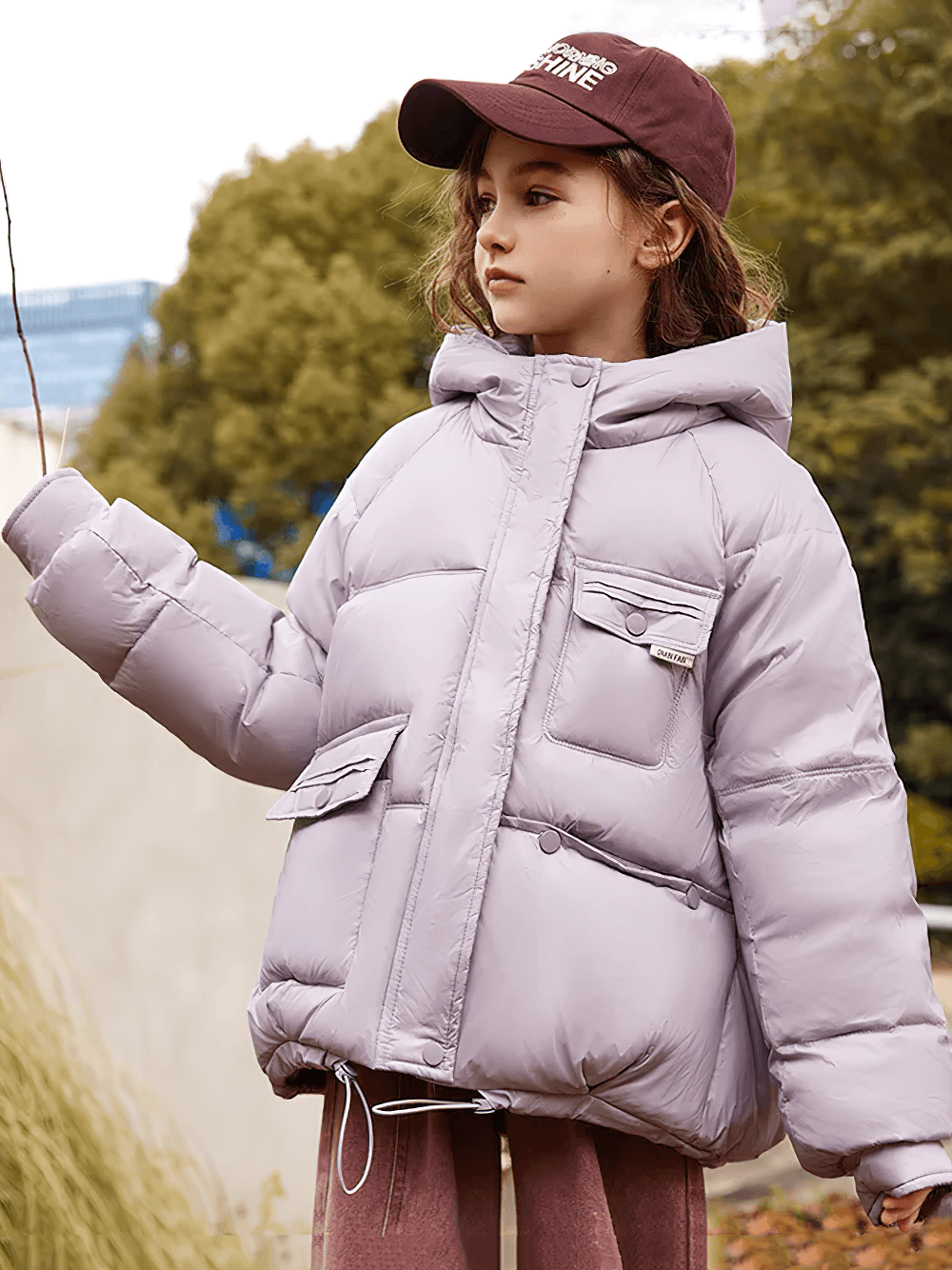 Young girl wearing Girls Duck Down Hooded Puffer Jacket With Pockets - SF3522, showing its warm and stylish design for winter.