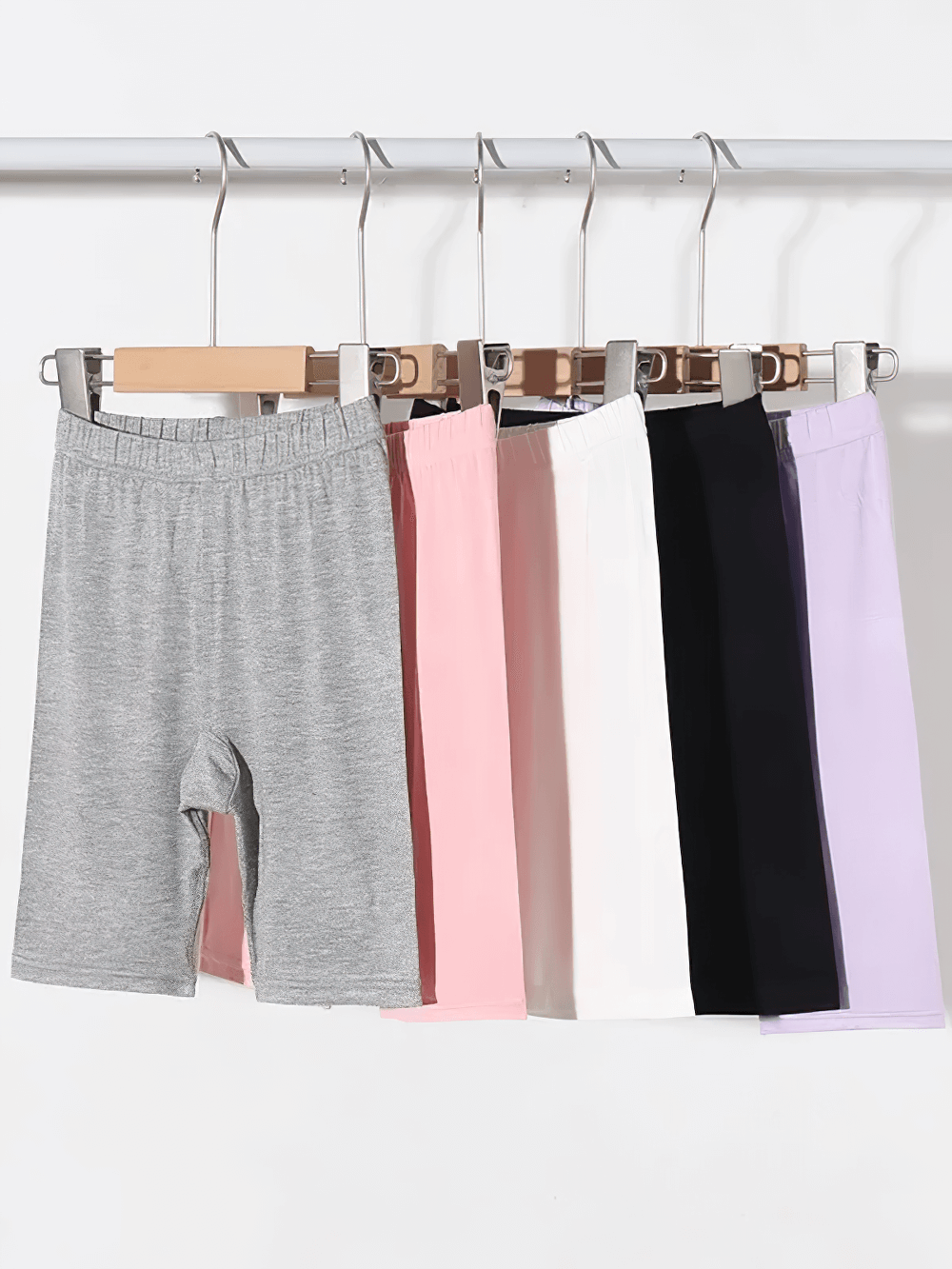 Girls Elastic Sport Capri Shorts for Active Play - SF3877 in various colors hanging on a rack, ideal for training and play.