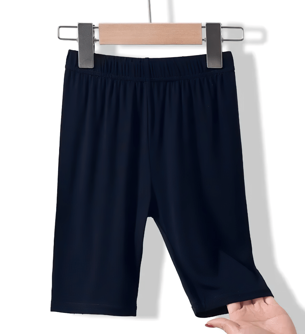 Girls Elastic Sport Capri Shorts for Active Play - SF3877 hanging on a clothes rack, showcasing elastic waist and lightweight fabric.