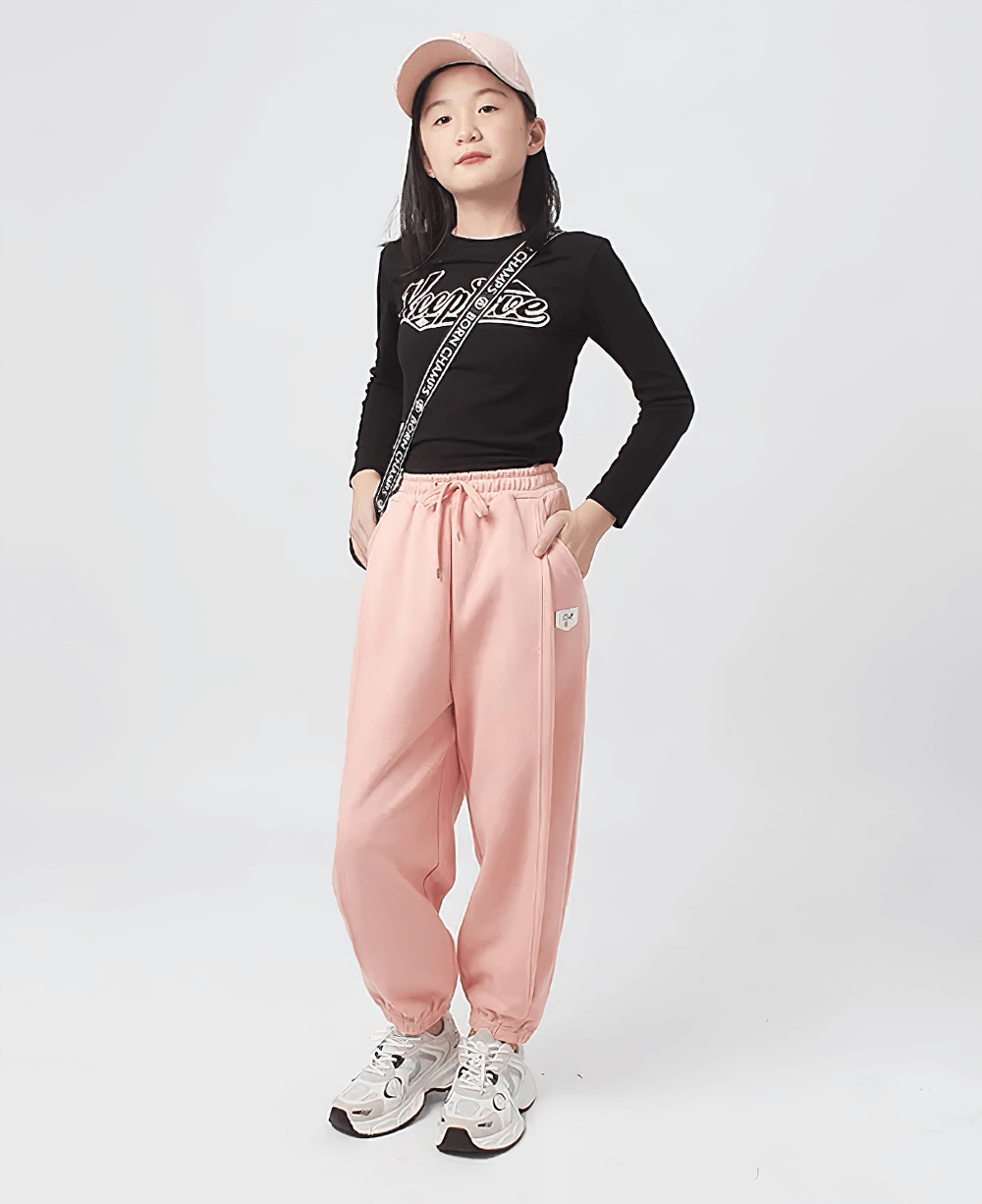 Girl wearing Girls High-Waist Cotton Jogger Pants with Pockets - SF3658, pink casual trousers with elastic waistband for comfortable style.