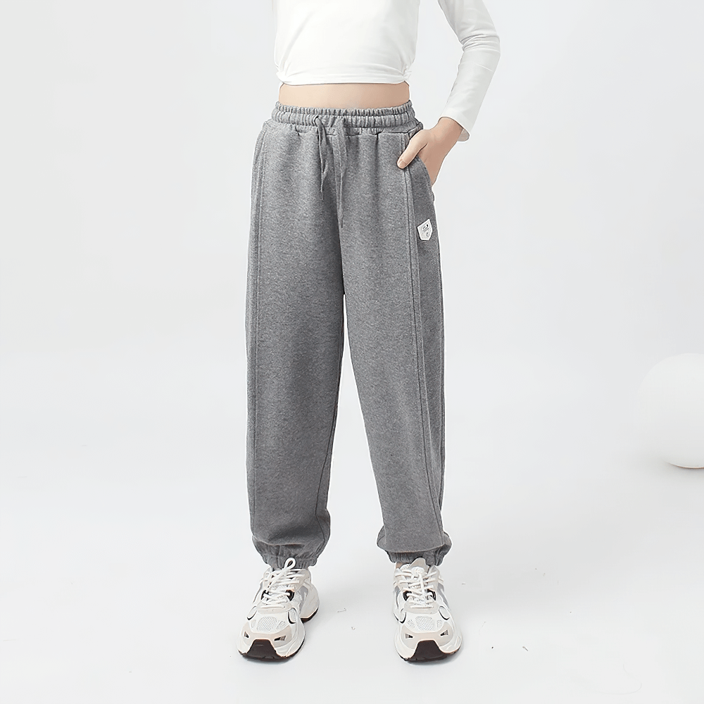 Girl wearing Girls High-Waist Cotton Jogger Pants with Pockets - SF3658, featuring a casual sporty style in grey color.