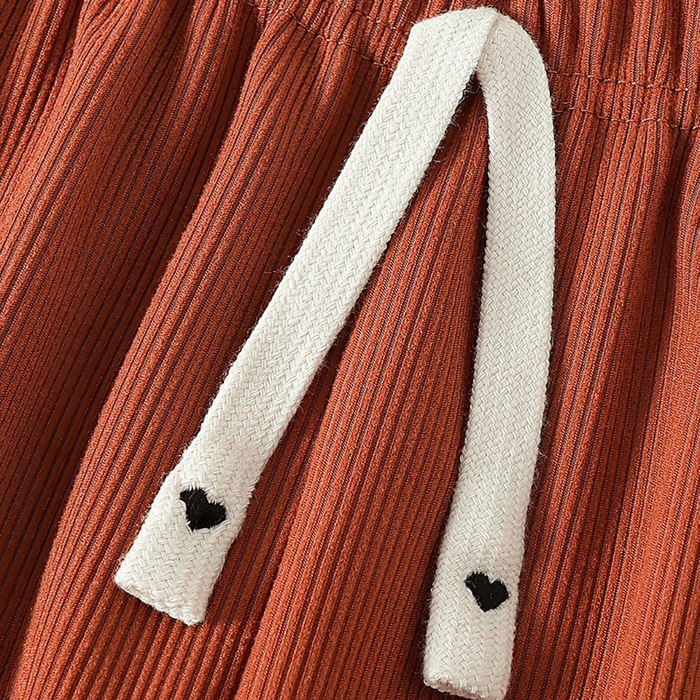 Close-up of the Girls Plush Lined Sport Jogger Pants With Bow - SF3875 showing ribbed fabric and cute heart detail on the drawstring.