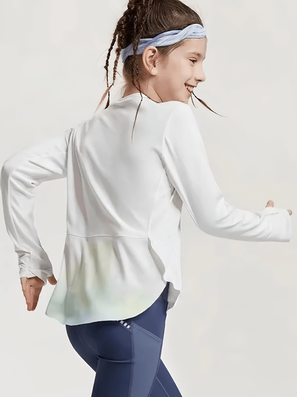 Active girl wearing Girls Quick Dry Long-Sleeved Sports Top for Yoga - SF3859, displaying flexible fit and crossed hem design in action.