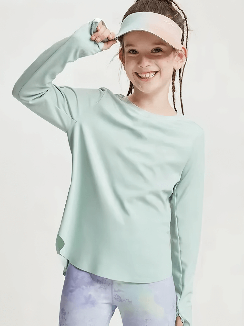 Smiling girl wearing Girls Quick Dry Long-Sleeved Sports Top for Yoga - SF3859 in green with a crossed hem, perfect for active kids.
