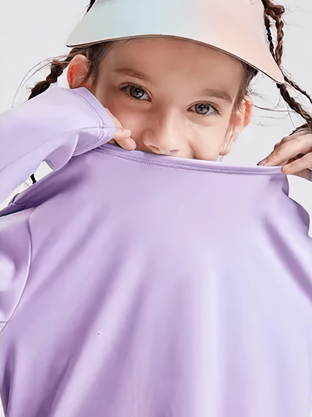 Young girl in purple Girls Quick Dry Long-Sleeved Sports Top for Yoga - SF3859 playfully pulling the collar, showcasing the soft fabric.