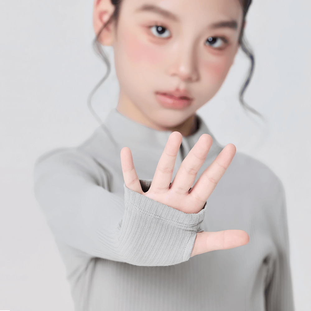 Young dancer wears Girls Ribbed Top with Half Zip and Thumb Holes - SF3924, showing thumb holes