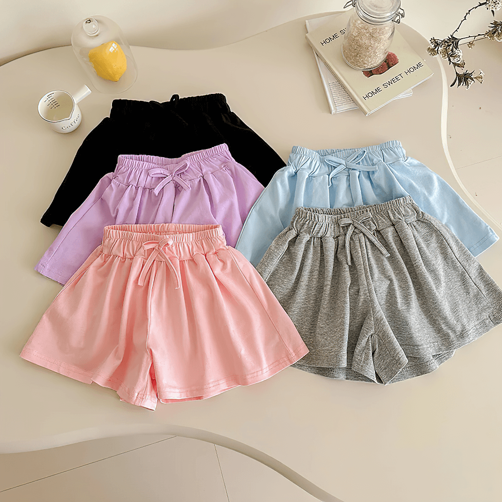 Colorful Girls' Soft Cotton Drawstring Loose Shorts - SF3737 displayed on a table, showcasing lightweight comfort and playful style.