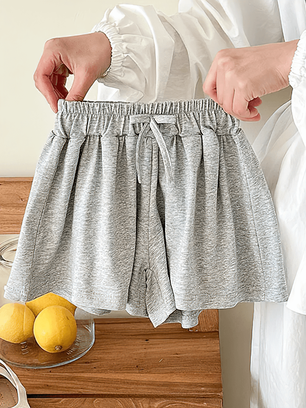 Person holding Girls' Soft Cotton Drawstring Loose Shorts - SF3737 in gray color for kids