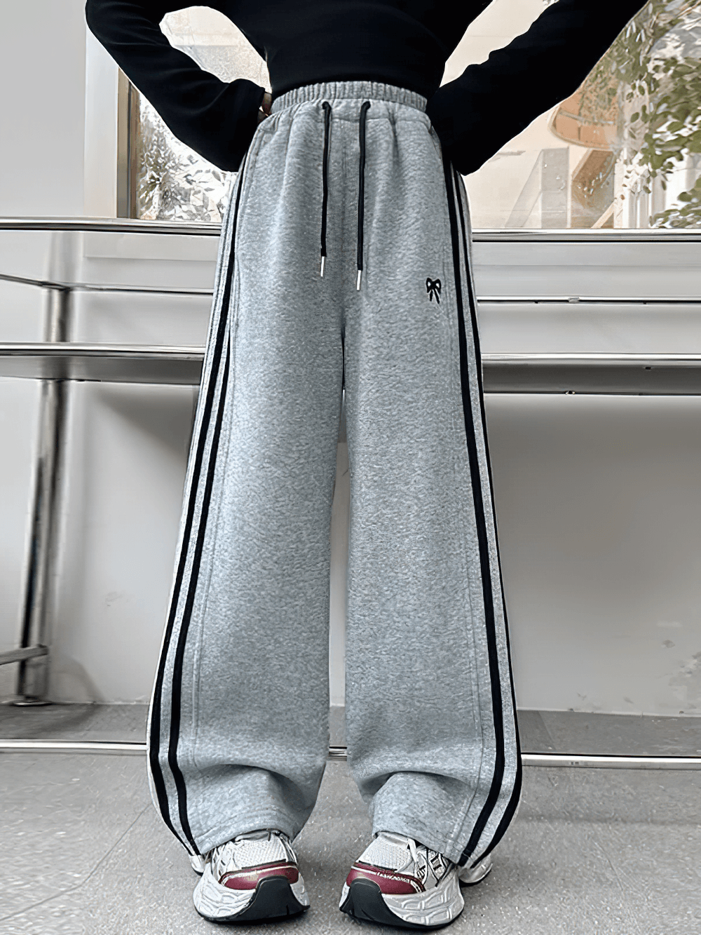 Model wearing Girls Sporty Pants with Side Stripes and Drawstring - SF3620, featuring a comfortable fit and sleek design.