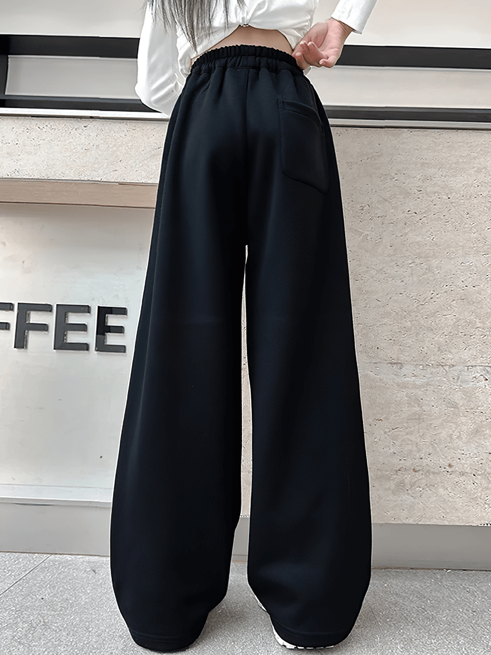 Girls Sporty Pants with Side Stripes and Drawstring - SF3620, back view showing loose fit and pocket design in casual setting.