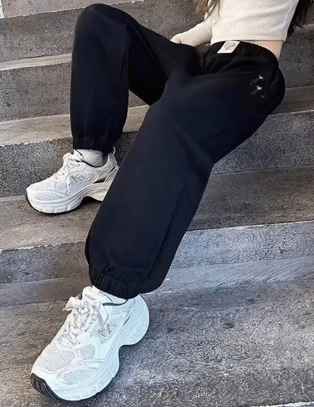 Girls Star Print Loose Sports Pants with Elastic Waist - SF3728 showcased on steps with stylish sneakers.