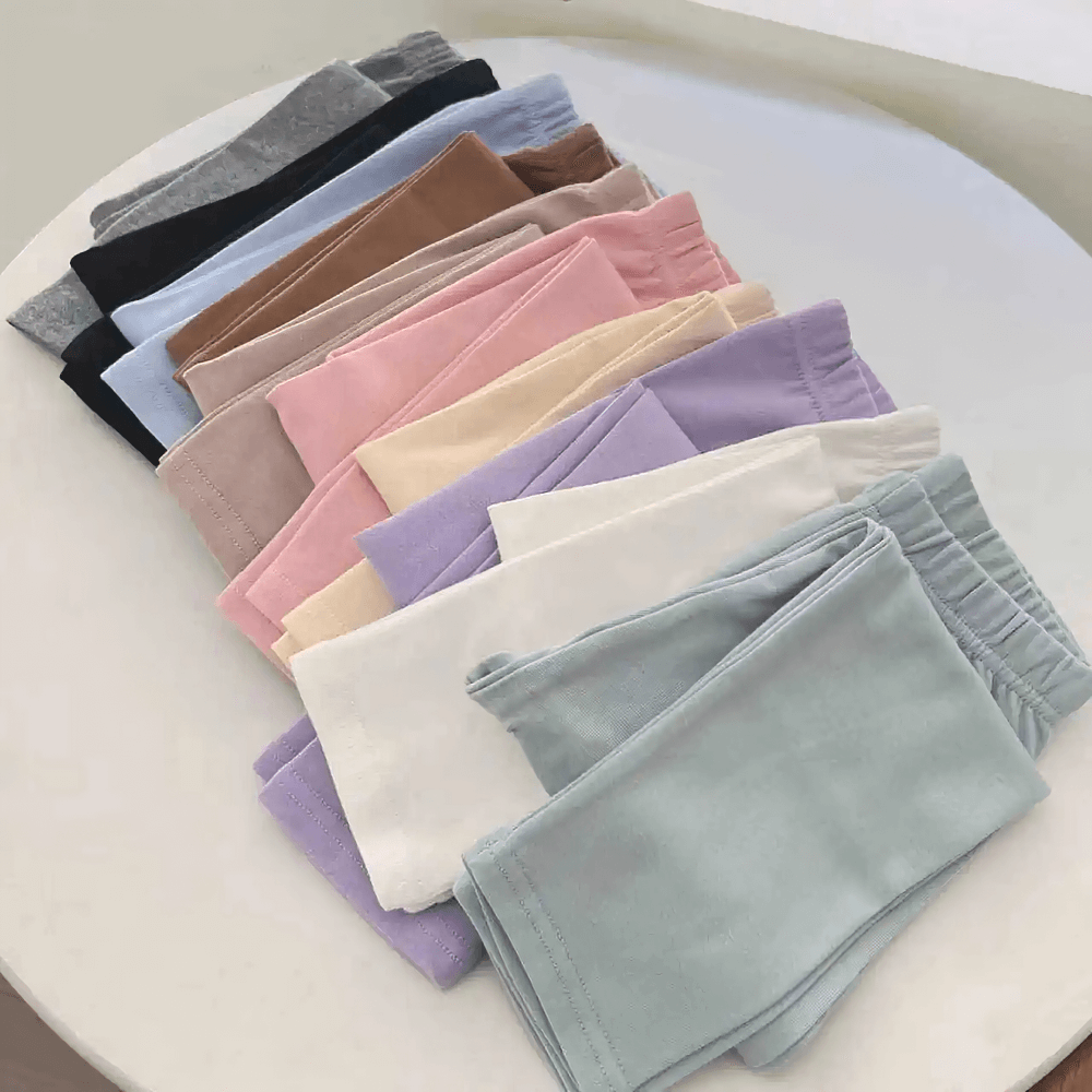 Girls Stretchy Sport Leggings in Soft Solid Colors - SF3681 displayed in vibrant array on table.