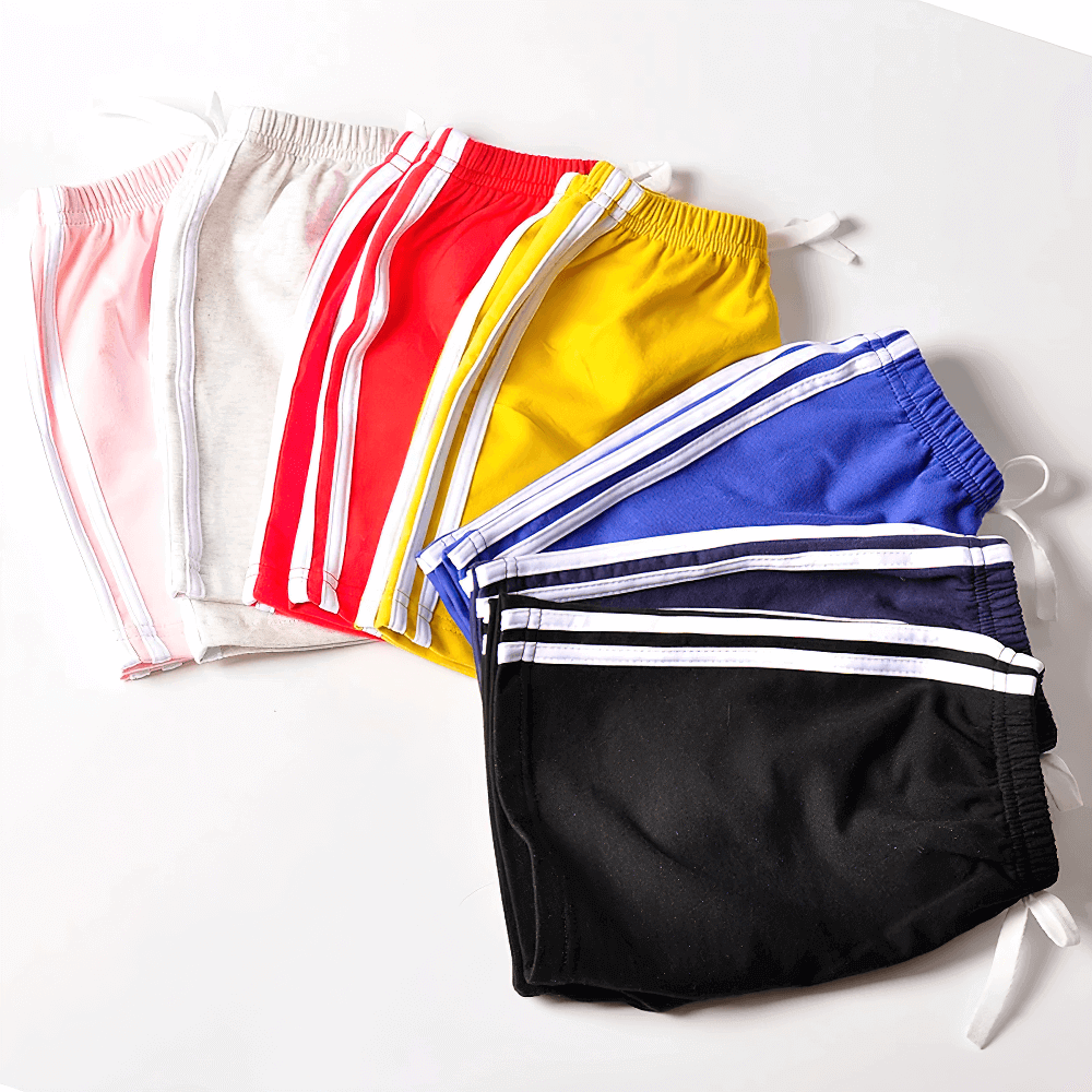 Colorful stack of Athletic Drawstring Shorts With Side Sport Stripes - SF3727 for kids, featuring breathable fabric and elastic waistband.