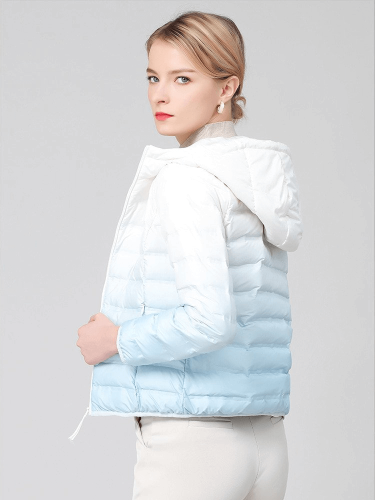 Gradient stylish women's down jacket with hood, featuring white and blue colors, zipper closure, and warm duck-down filling.