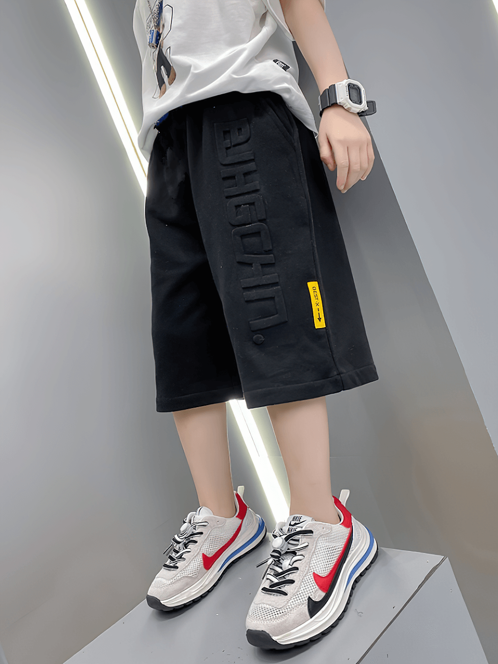 Kid wearing Graphic Drawstring Knee-Length Sports Shorts - SF3771 with trendy graphic print and relaxed fit.