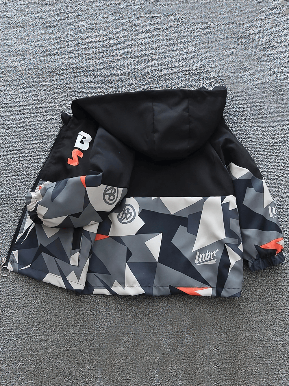 Graphic Zip Jacket with Hood and Contrast Panels - SF3535 featuring bold geometric print in black, gray, and orange with elastic cuffs.
