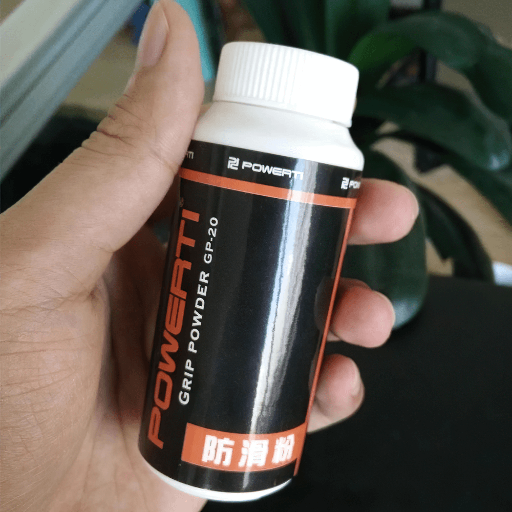 Person holding Grip Powder for Weightlifting and Climbing - SF3556 bottle in a gym setting.