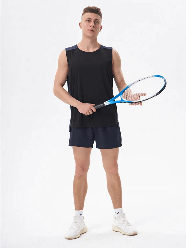 Man in breathable gym tank top holding tennis racket, ready for action. Perfect athletic wear for staying cool during workouts.