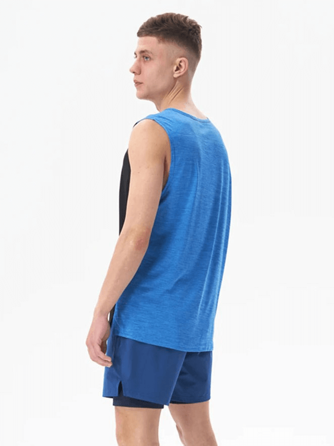 Man modeling Gym Breathable Double Color Tank Top SF1813 in blue, perfect for workouts. Made from lightweight, breathable polyester.