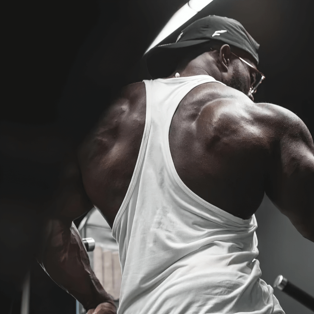 Man wearing Gym Tank Top with Bold Barbell Logo for Training - SF4095, perfect for weightlifting and intense fitness sessions.