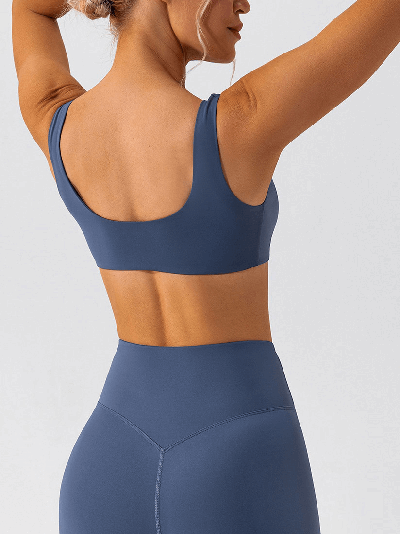 Woman wearing a Gym Workout Breathable Seamless Sports Bra in navy blue, showcasing comfort and style for active females.