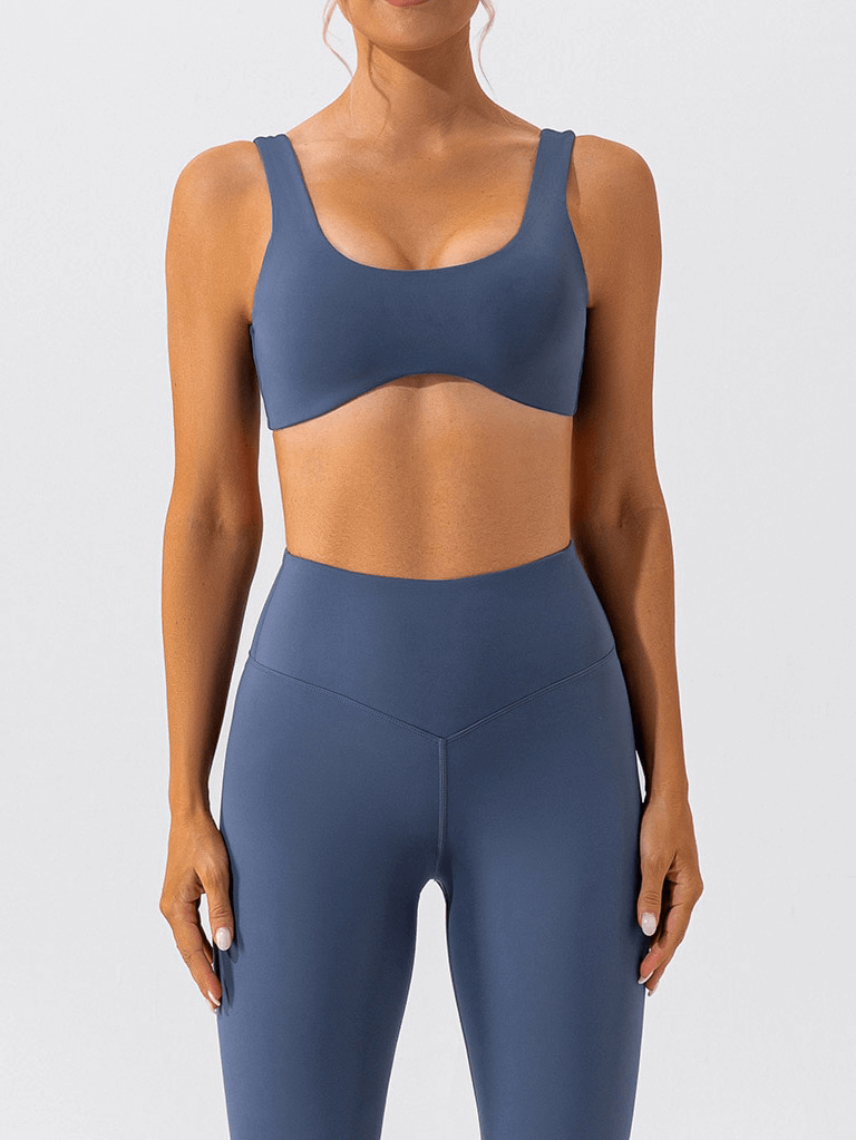 Woman wearing gym workout breathable seamless sports bra SF1314 in blue, designed for comfort and support during yoga and fitness activities.