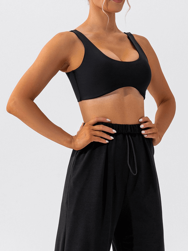 Woman wearing black seamless sports bra SF1314 designed for breathability and comfort, perfect for yoga and workouts.