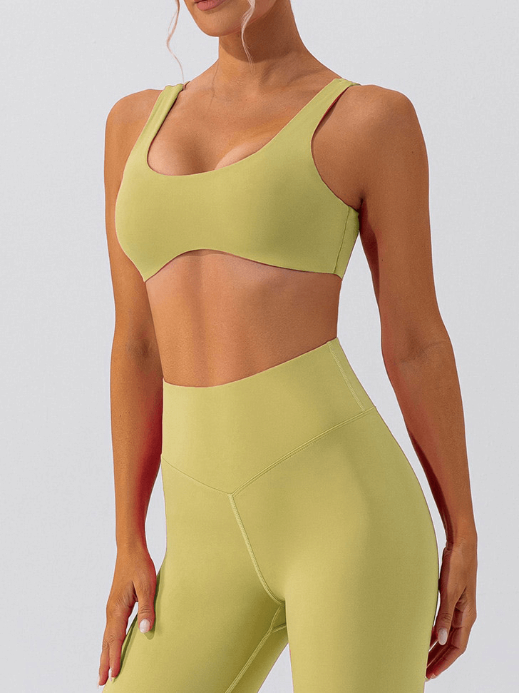 Woman wearing lime green breathable seamless sports bra and leggings, perfect for gym workouts and yoga sessions.