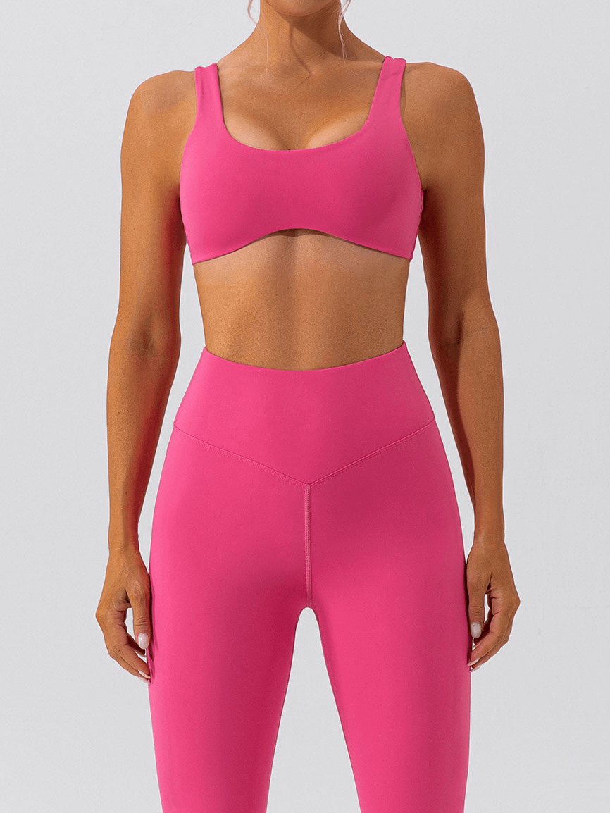 Woman wearing pink seamless sports bra and leggings set for gym workout, showcasing breathable and comfortable sportswear SF1314.