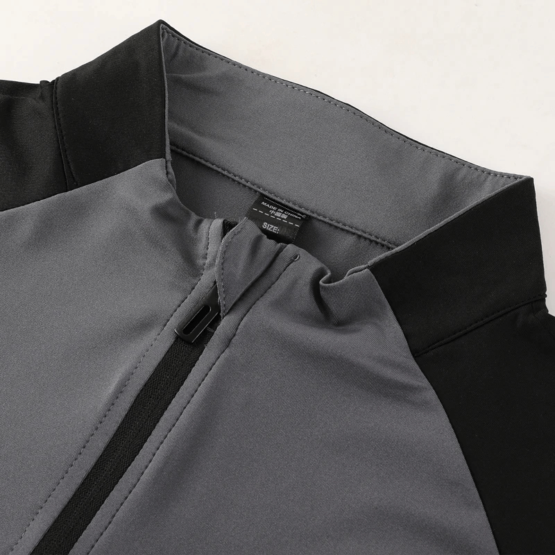 Close-up of Half-Zip Athletic Colorblock Fit Training Top in grey and black, showcasing the quick-dry fabric and style details.