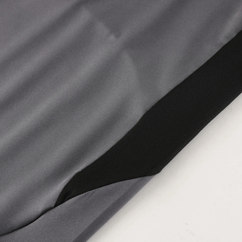Close-up of the black and gray colorblock fabric on the Half-Zip Athletic Fit Training Top, showcasing its sleek design and performance material.