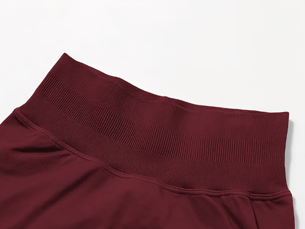 Close-up of maroon seamless high-waisted shorts, showcasing ribbed waistband for support and comfort.