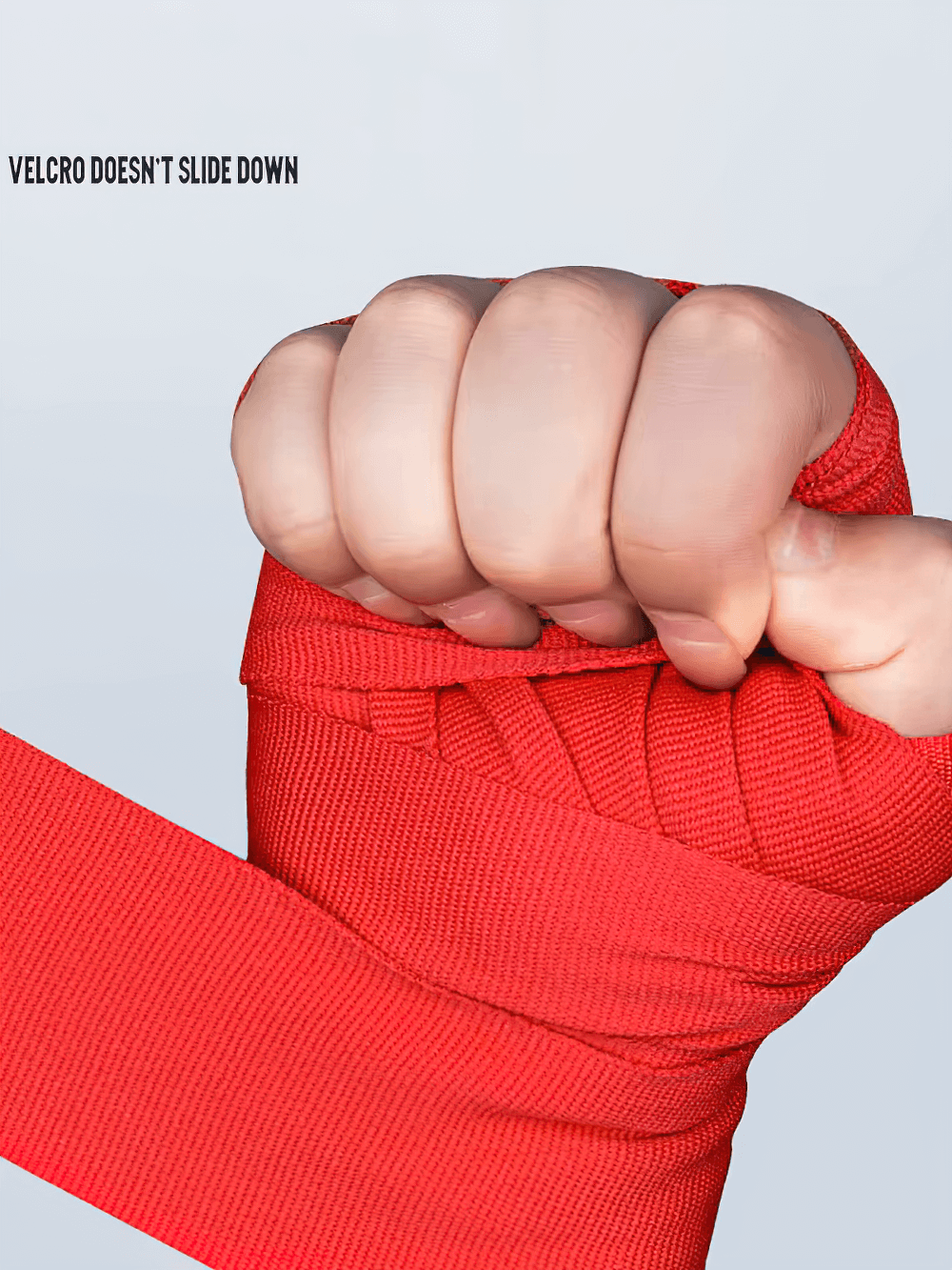 Red boxing hand wraps with thumb buckle and velcro closure for wrist support.
